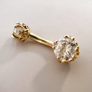 Close-up of 14k yellow gold belly ring highlighting 5mm VS1 diamond in ornate filigree prong setting