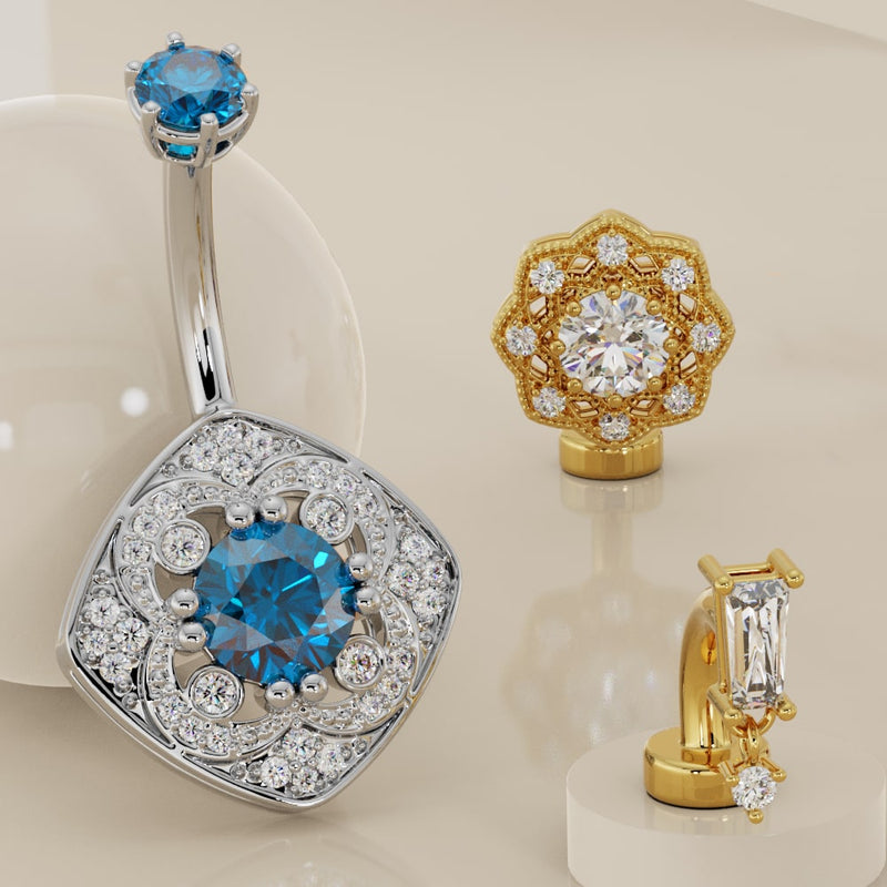 Assorted 14K gold floating belly rings displayed together showing style variety