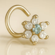 14K yellow gold CZ flower nose ring twist with aqua center stone, angled close-up view