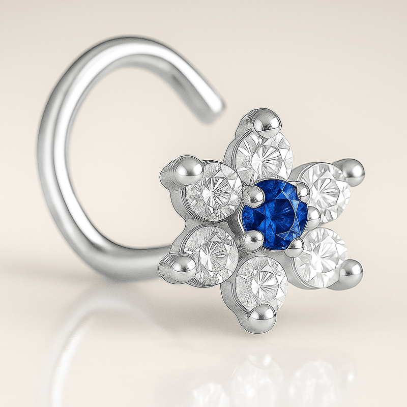 14K white gold CZ flower nose ring twist with blue sapphire center CZ, angled studio close-up
