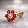 14k yellow gold red CZ flower flat back labret with clear center stone, angled product shot