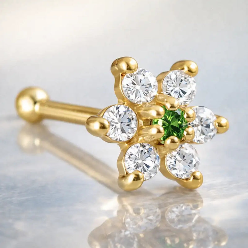 14K yellow gold CZ flower nose bone with dark green emerald CZ center, angled product view