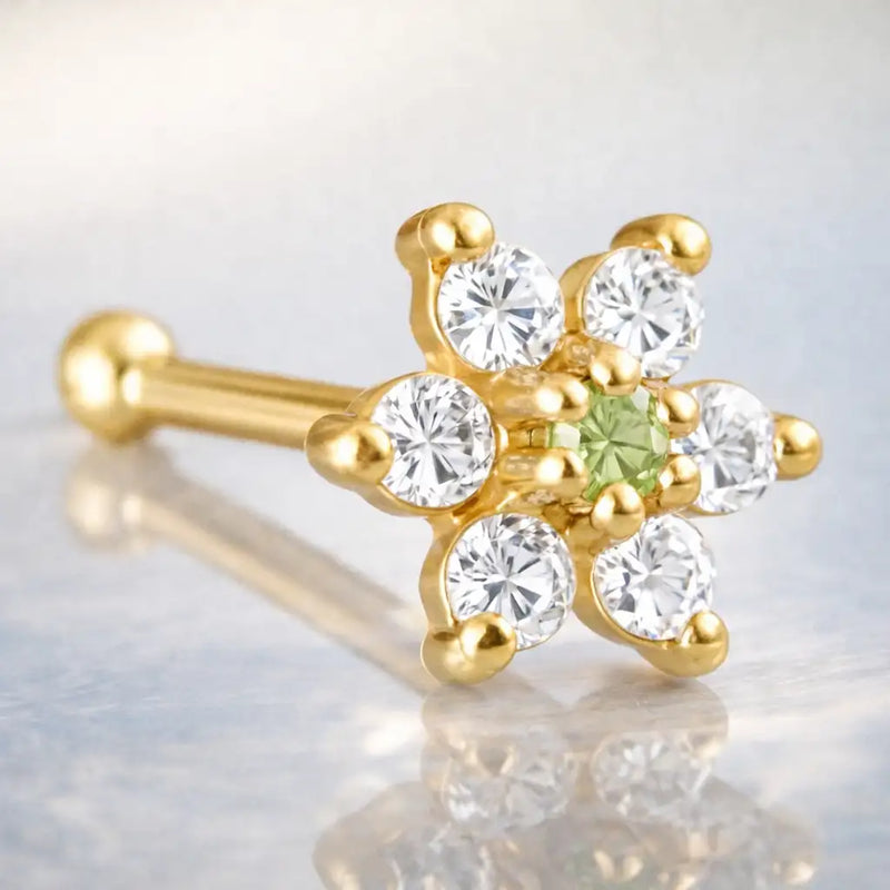 14K yellow gold flower nose bone with light green peridot CZ center and clear CZ petals, angled view