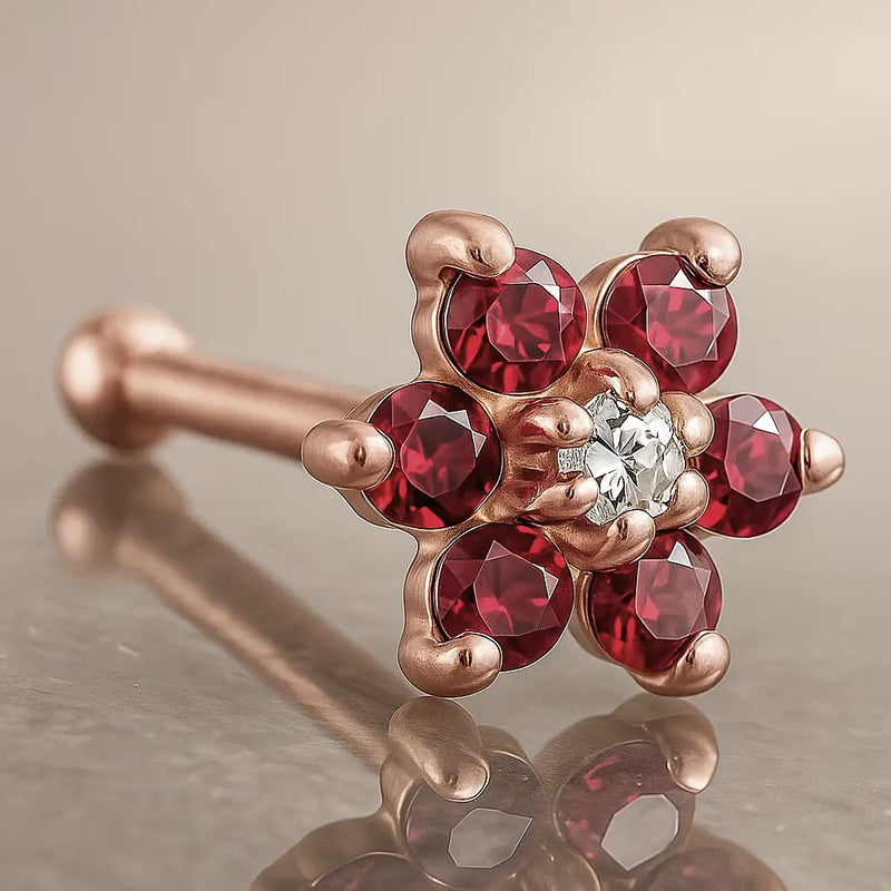 14K rose gold flower nose bone with red CZ petals and clear CZ center, angled product view