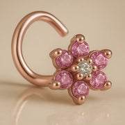 14K rose gold flower nose twist with pink CZ petals and clear center stone, angled view