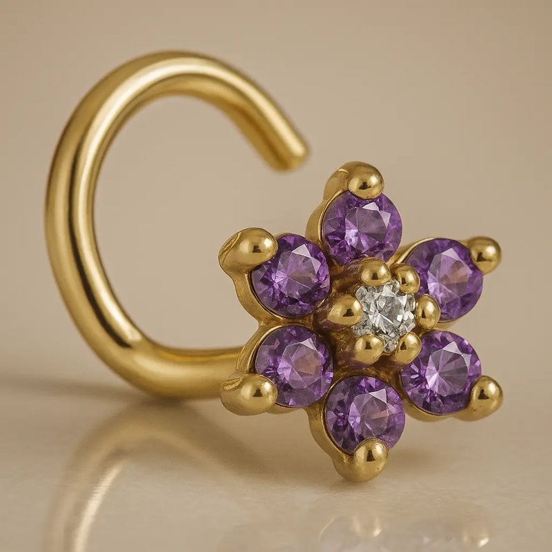 14K yellow gold flower nose twist with purple CZ petals and clear center stone, angled view
