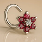 14K white gold flower nose twist with red CZ petals and clear center CZ, close angled view