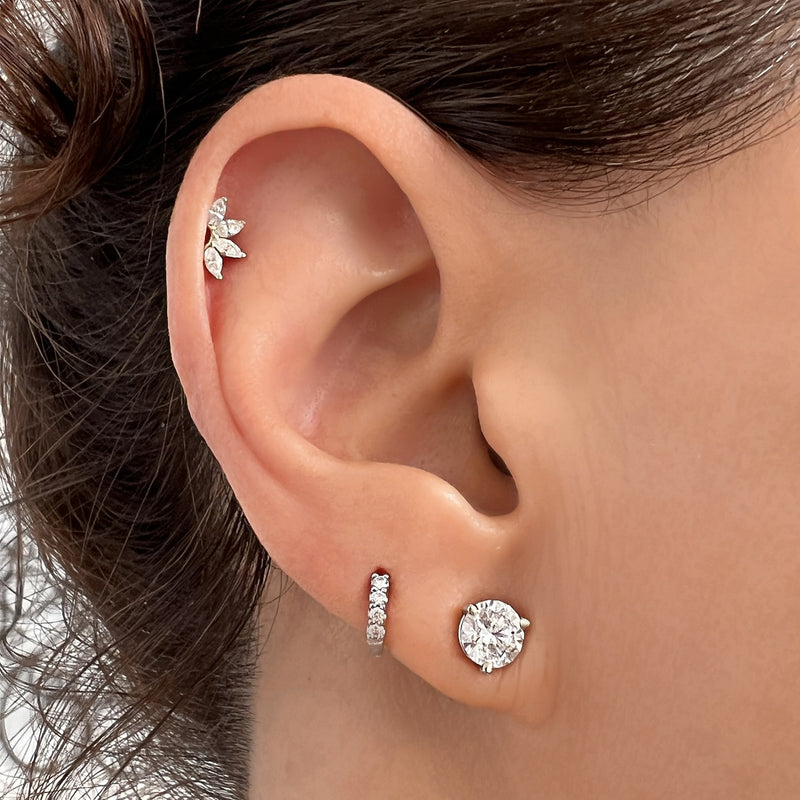 Marquise fan CZ stud end shown in flat piercing on model's ear, white gold finish