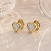 14k yellow gold diamond heart stud earrings pair, bezel-set sparkle, styled on reflective surface