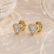 14k yellow gold diamond heart stud earrings pair, bezel-set sparkle, styled on reflective surface