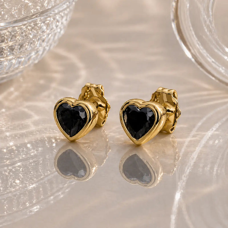 14k yellow gold onyx heart stud earrings pair, bold black bezel-set stones on pearlescent surface