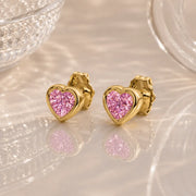 14k yellow gold pink sapphire heart stud earrings pair, bezel-set bright pink stones on soft background