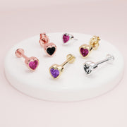 Assorted heart flat back stud earrings in multiple stone colors and gold metals on white display
