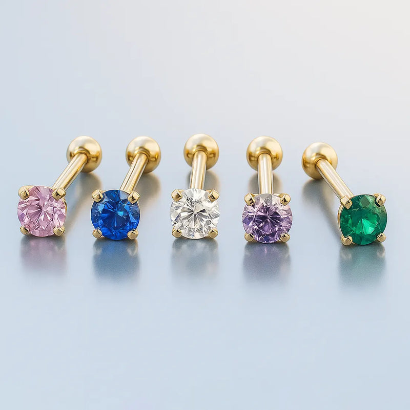 Five 2mm birthstone cartilage studs in 14k yellow gold showing pink, blue, clear, lavender, and green gemstone options