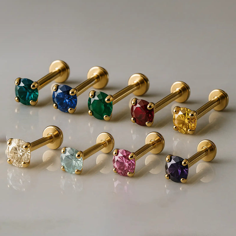 14K yellow gold prong-set flat back labrets in nine gemstone colors including emerald, sapphire, ruby, and amethyst