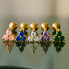 14k yellow gold triple birthstone cartilage earrings in five gemstone colors lined up for comparison