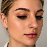 14k gold seam ring hoop worn as a nostril ring, front-facing close-up beauty shot on model
