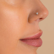 3mm heart diamond nose ring shown in pierced nostril on model, side profile view