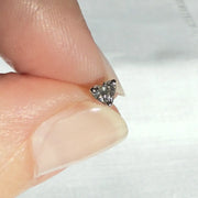 3mm heart-cut diamond labret end held between fingertips showing actual tiny size for scale