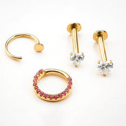 14k yellow gold heart CZ labret shown alongside other gold piercing jewelry styles for mix-and-match inspo