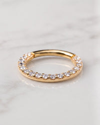 Clicker rings - 14k yellow gold gem pave clicker hoop with front-facing stones on white marble