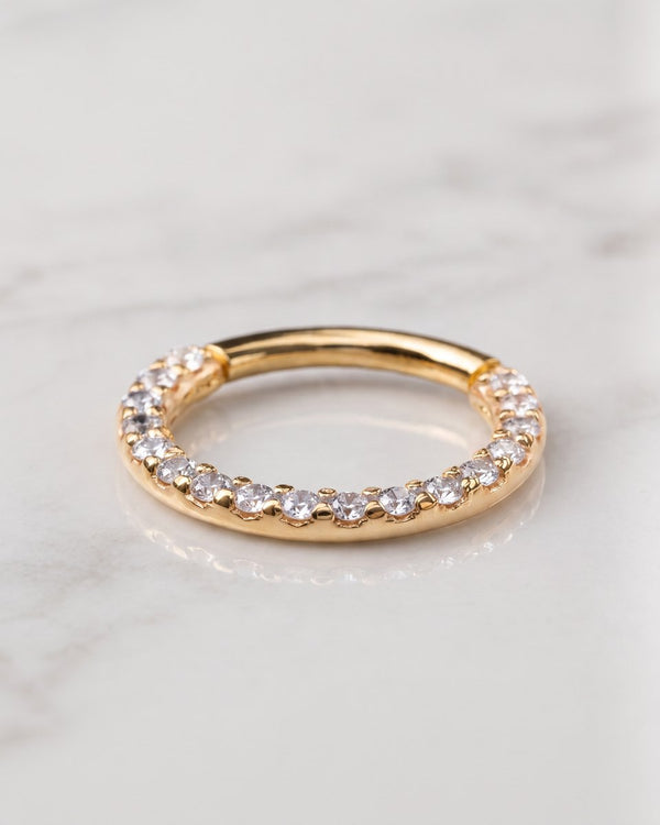 Clicker rings - 14k yellow gold gem pave clicker hoop with front-facing stones on white marble