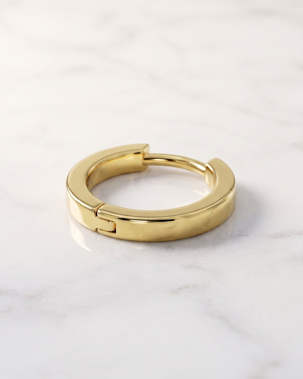 Hoop earrings - plain 14k yellow gold huggie hoop earring with hinged closure on white marble