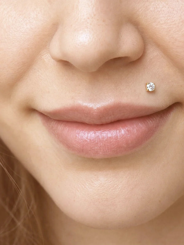 Diamond labret stud worn in a Monroe lip piercing