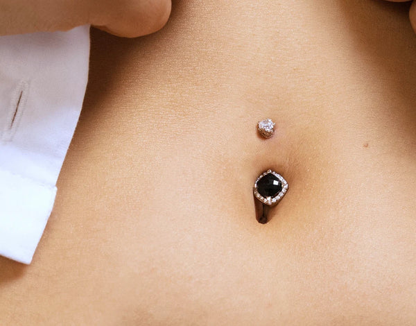 Black onyx and diamond 14k gold belly button ring worn in a navel piercing