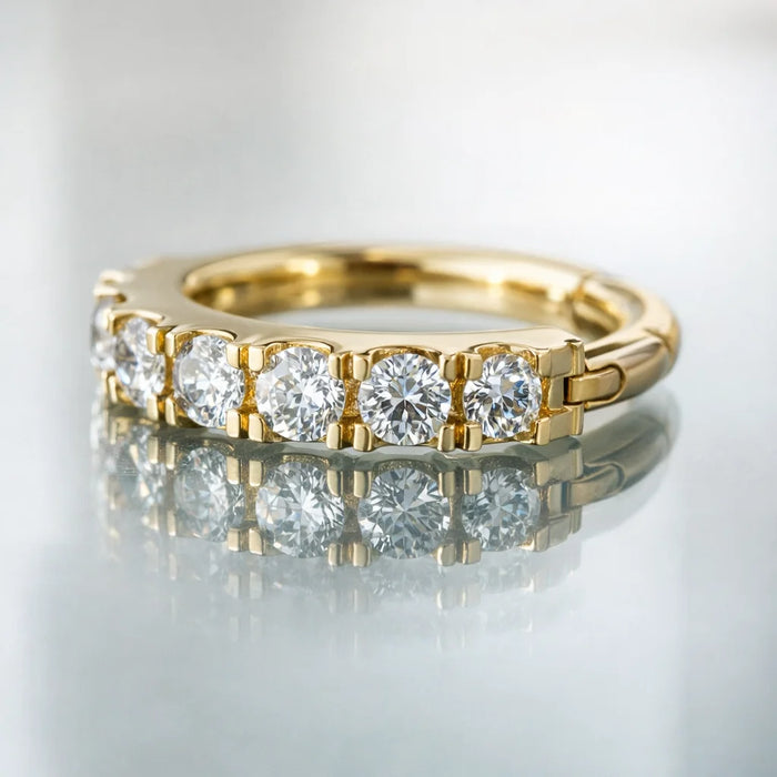 Close-up of 14k yellow gold CZ infinity clicker showing round CZ prong detail and hinge mechanism