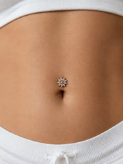 Close-up of a model's navel wearing the Jasmine diamond floating navel ring - a diamond flower cluster in 14k gold