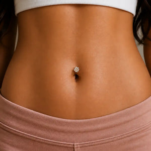 Close-up of a person's waist with a Jasmine diamond floating belly button ring.