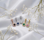 La Reina 14k gold navel rings in rose, white, and yellow gold with multiple gemstone options on silk
