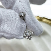 Majesty's Rose navel ring in white gold with diamonds held between white gloves.