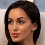 14k gold 10mm huggie hoop shown on model's ear, demonstrating close, minimal fit against the lobe