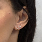 14k gold marijuana leaf cartilage stud shown on pierced ear alongside a gold hoop for scale and fit