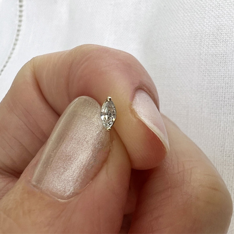 2.5mm marquise-cut diamond nose ring end held between fingers for size reference