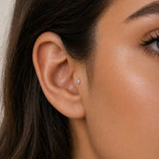 14k white gold marquise diamond flat back stud worn in lobe piercing, showing fit and scale