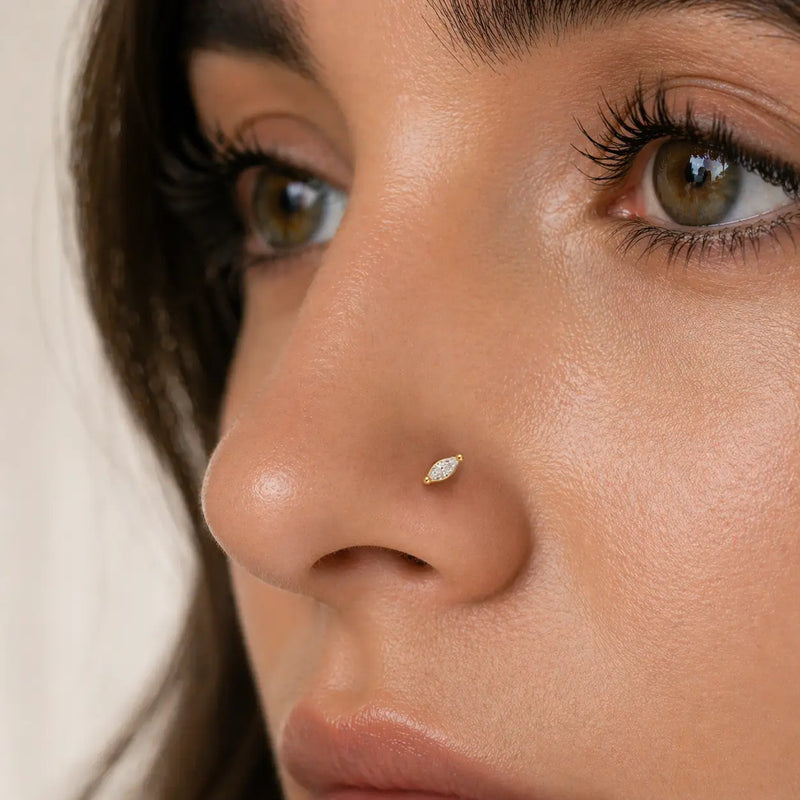 14k yellow gold marquise diamond labret stud worn in nostril piercing, close-up front view