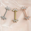 Marquise fan nipple barbells in 14K white, yellow, and rose gold with clear stones on blush satin