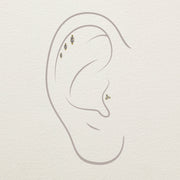 Illustration of marquise diamond stud ends placed in helix and conch piercing positions on ear