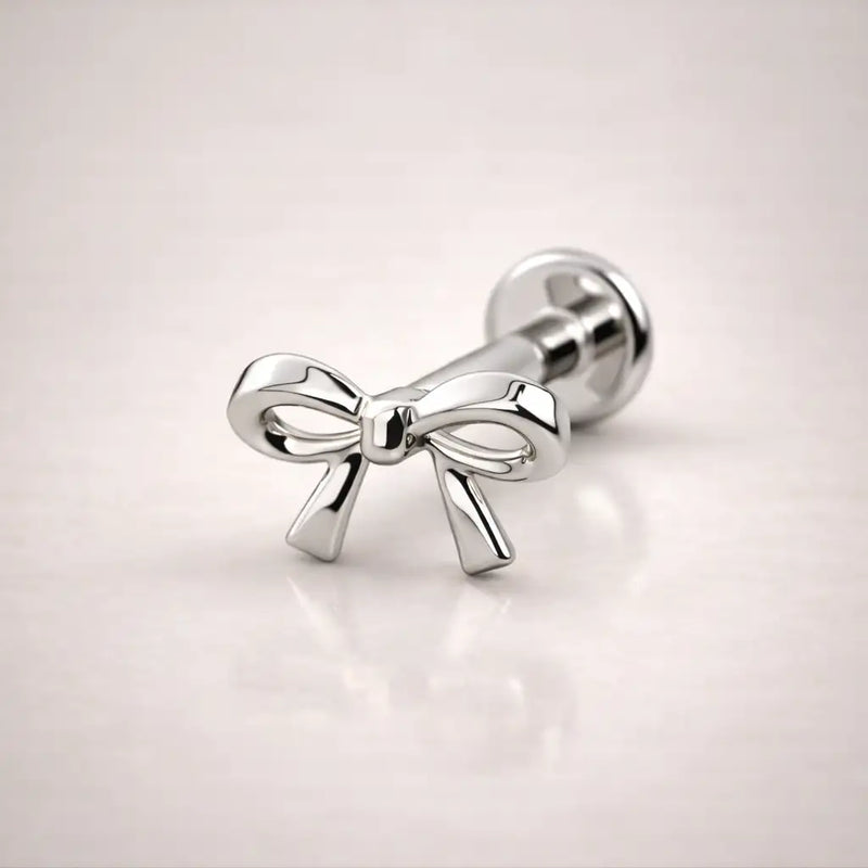 14k white gold bow flat back labret stud, angled view showing sculpted silhouette and flat backing