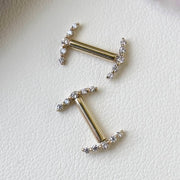 Two 14k yellow gold diamond climber nipple barbells laid flat, showing scale and delicate VS1 diamond settings