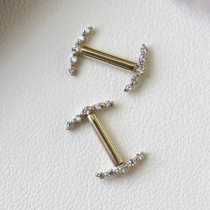 Two 14k yellow gold diamond climber nipple barbells laid flat, showing scale and delicate VS1 diamond settings