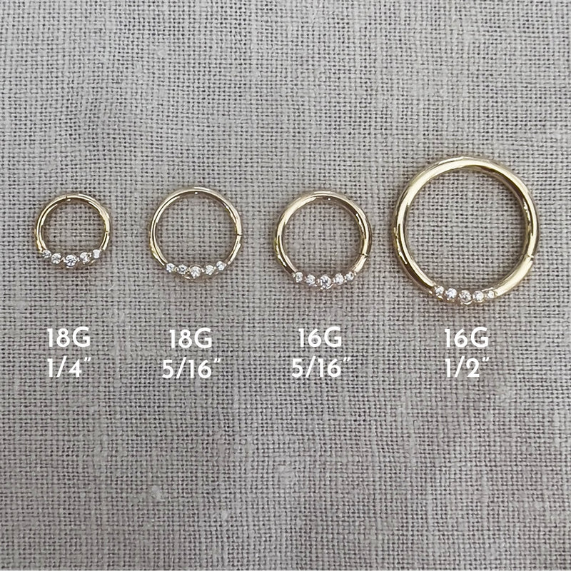 14K yellow gold CZ seam ring shown in four sizes: 18G 1/4", 18G 5/16", 16G 5/16", and 16G 1/2"