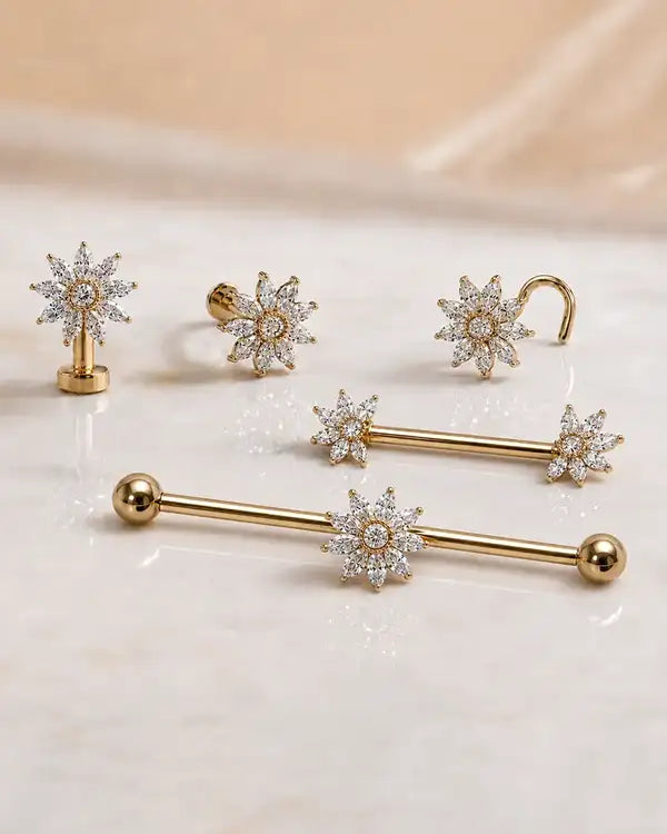 Array of 14k gold and diamond jewelry on a light background