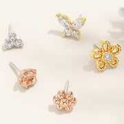 Assorted 14k gold threadless piercing ends including yellow gold daisy milgrain flower with diamond center