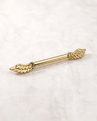 Fancy nipple barbells - 14k yellow gold winged nipple barbell on white marble