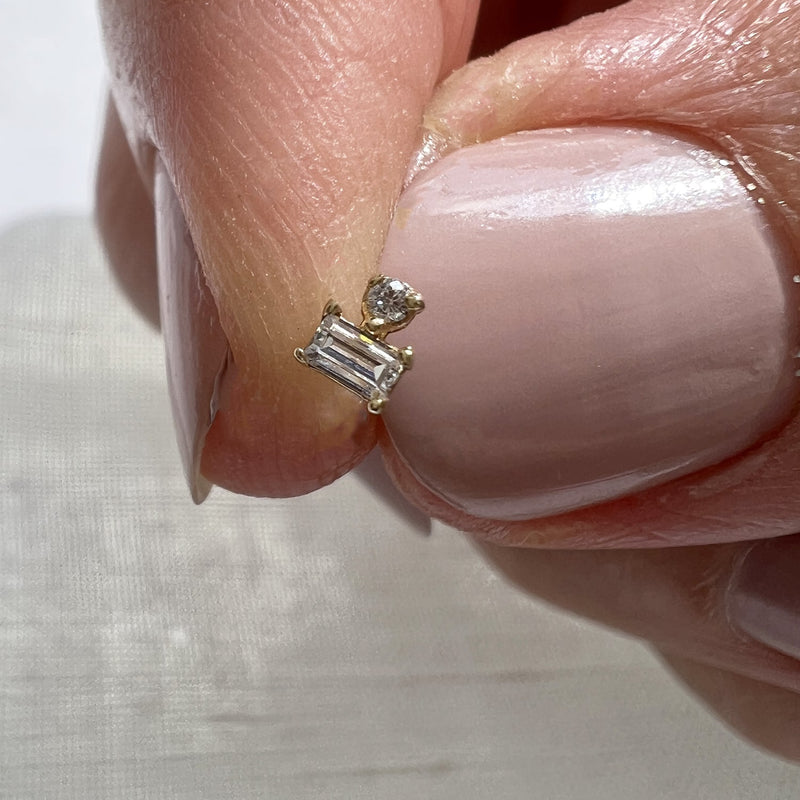14k yellow gold diamond push pin end held between fingers for size reference