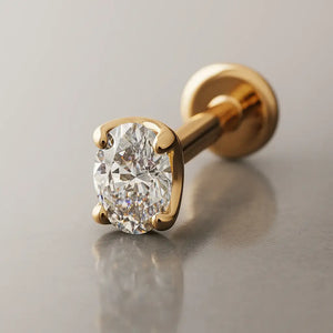 14k yellow gold 3mm oval-cut diamond flat back labret, angled studio shot showing 4-prong setting and post